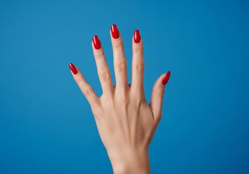 Woman's hand with red nails against blue background, blm Ups 222