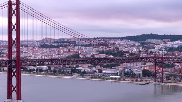 Ponte 25 de Abril suspension bridge at sunset on Tagus River estuary, Lisbon, Drone shot