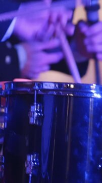 Drum performer plays drumstick at the stage
