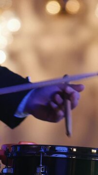 Drum performer plays drumstick at the stage