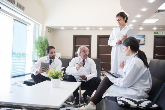 Medical team meeting in a modern Middle Eastern eye hospital clinic in Egypt discussing patient care and surgery