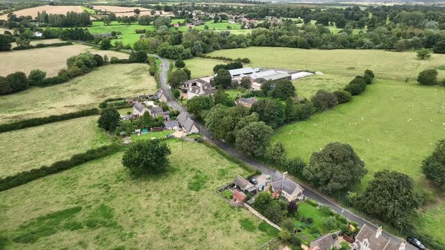 Aerial Drone View of Farm Buildings and Country Road in Northamptonshire English Countryside