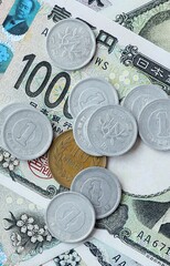Japanese yen money bills and coins on table. Japan cash of JPY currency close up © Larysa