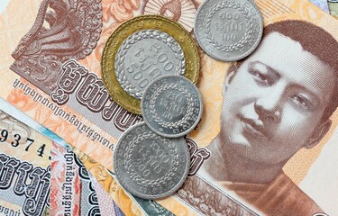 Cambodian riel money bills and coins on table. Cambodia cash of KHR currency © Larysa