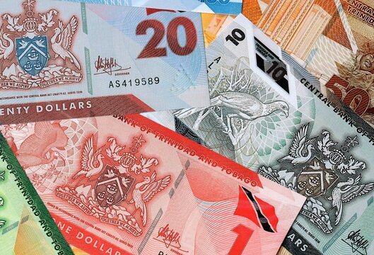 Trinidad and Tobago dollar money banknotes bunch on table. Trinidad and Tobago bills of TTD currency