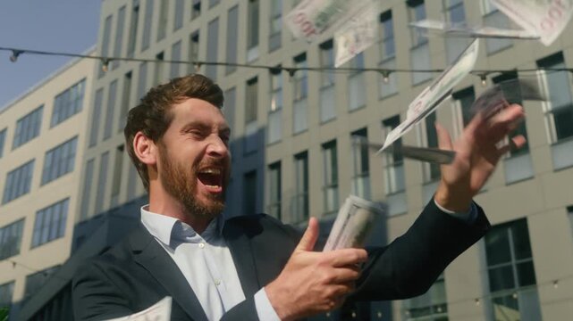 Happy rich Caucasian business man throwing money outside city celebrating success wealthy male businessman employer winner yell excited cash banknotes finance salary profit investment worker outdoors