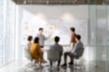 Fototapeta premium Blurred Team collaborating on business strategy with whiteboard and sticky notes