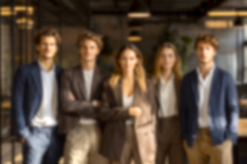 Fototapeta premium Blurred Diverse Business Team Standing Confidently in Modern Office Environment