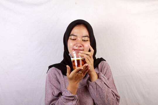 young woman eating a glass of  bubur biji salak