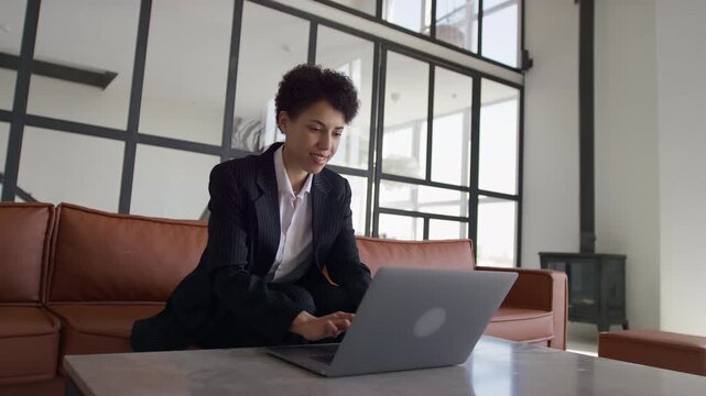 Businesswoman Using Laptop In Modern Office