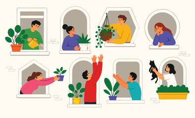 Fototapeta premium People waving and looking out of building windows.