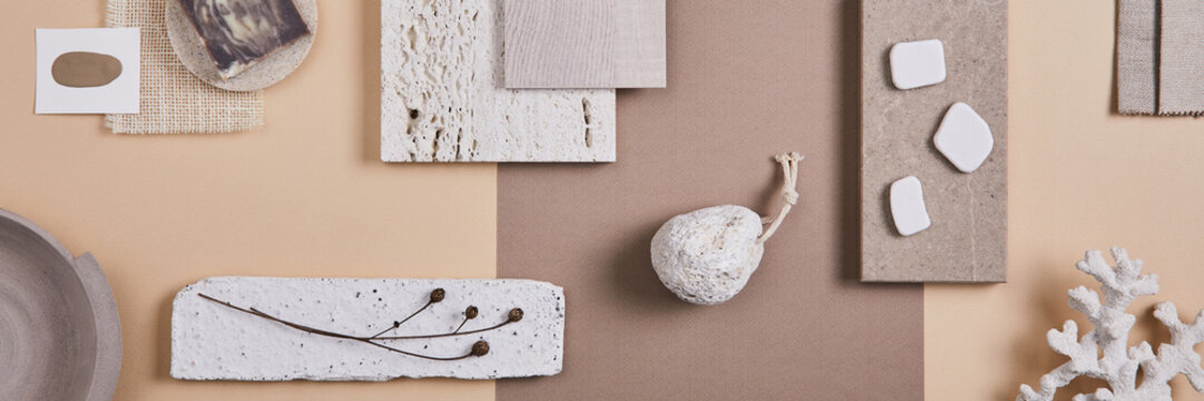 Creative interior designer moodboard. Flat lay composition with textile and paint samples, panels and cement tiles. Beige and grey color palette. Copy space. Template.