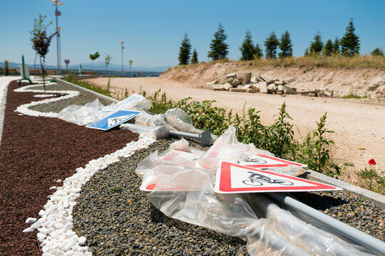 Uninstalled traffic signs in urban park under reconstruction. City infrastructure modernization and public area renovation