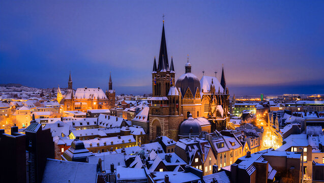 Beautiful winter evening cityscape with historic cathedral and snowcovered rooftops glowing warmly under twilight sky
