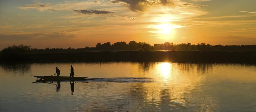 Sunset in Cavallino Harbour, fishing boat, view of lagoon, Venice, Italy