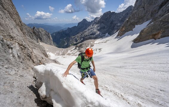 Mountaineer on a snowfield, mountain basin with glacier remnant of the H&ouml;llentalferner, H&ouml;llental, rocky mountain peaks, H&ouml;llental, Bavaria, Germany