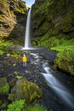 Tourist at Kvernufoss waterfall, in summer when the weather is nice, gorge and river, long exposure, Skogar, Sudurland, South Iceland, Iceland