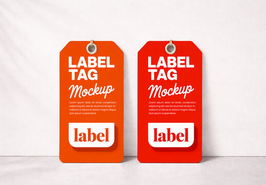 Two Vertical Clothing Label Tag Mockups in Orange and Red Leaning Against White Wall