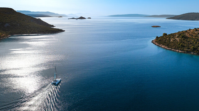 yacht exiting bay toward open sea, Adriatic coast, Croatia