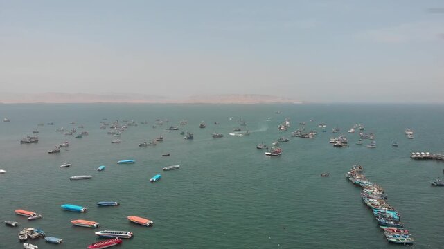 Aerial view of Paracas Bay with tourist boats and pier, Ica, Peru.