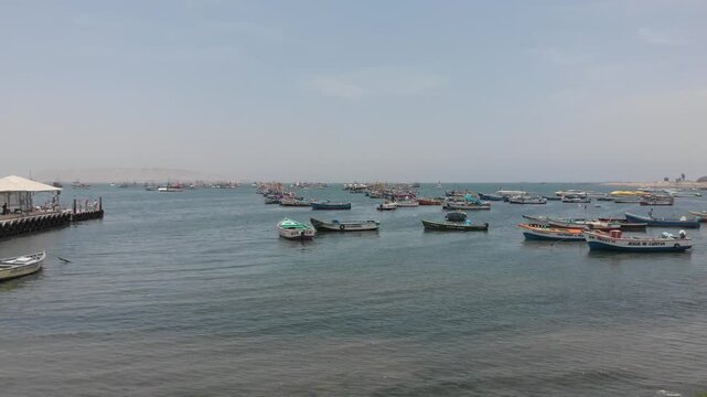 Aerial view of Paracas Bay with tourist boats and pier, Ica, Peru.