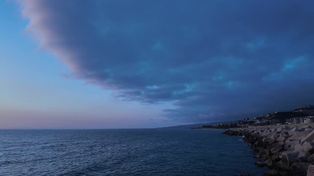 180-Degree Camera Pan from Lit Coastal Town to Open Sea with Pink Cloud at Dusk &ndash; Mediterranean Blue Hour, Lebanon