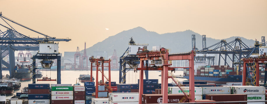 Hong Kong, China, 8 March 2026: panoramic view of cargo cranes, container ships and stacked shipping containers at Kwai Tsing container terminals. Kwai Chung.