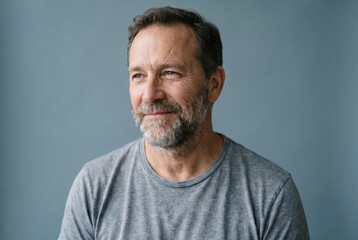 Fototapeta premium Content Middle-Aged Man with Grey Beard in Grey T-Shirt