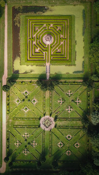 Aerial view of the geometric hedge maze and symmetrical parterre gardens at Chateau de Cormatin in Cormatin, Bourgogne-Franche-Comte, France.