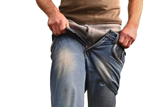 Close-up of man wearing jeans over thermal underwear. Concept of layering clothes for warmth and comfort in cold weather. human pulls on jeans over warm long johns. isolate on white background.