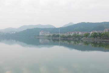 Fototapeta premium The city and its landscape in the morning mist and rain