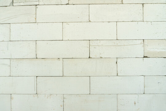 A wall made of lightweight concrete blocks, specifically autoclaved aerated concrete blocks. These blocks are designed for building construction and are often used to create internal or external walls