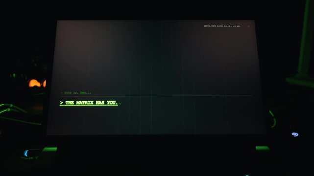 Glowing green terminal interface on a laptop screen displays a mysterious message from a digital simulation in a dark room. Concept of artificial intelligence, matrix, and computer hacking.