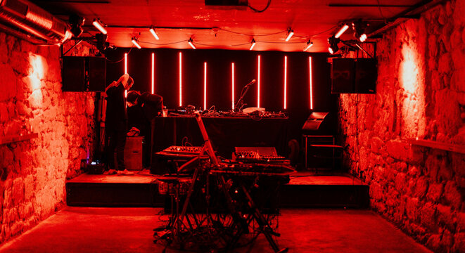 Red Lit Underground Music Club With DJ Stage Setup