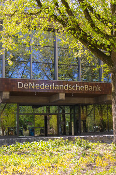 Amsterdam, Netherlands - 30 April 2026: De Nederlandsche Bank headquarters in Amsterdam and greenery around the building on a sunny day.