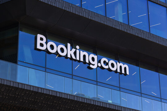 Amsterdam, Netherlands - 30 April 2026: The logo of Booking.com is seen on the exterior of an office building dedicated to travel services in an urban setting.
