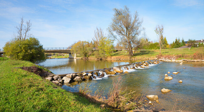 Mangfall river with rocks and cascade, bridge. blue sky  with space. bavarian landscape