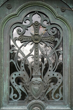 Decorative iron door grille with ornate scrollwork