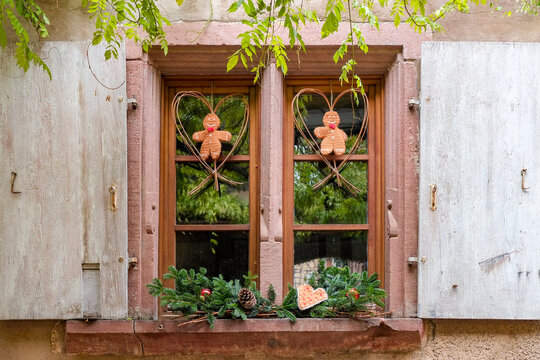 Decorative window with rustic trim and gingerbread men in Riquewihr