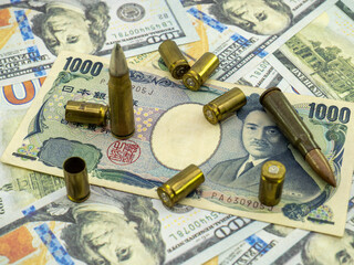 Naklejka premium japansese yen and ammunition spread, arming buying concept