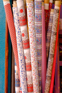 Colorful patterned fabric rolls in Paris shop