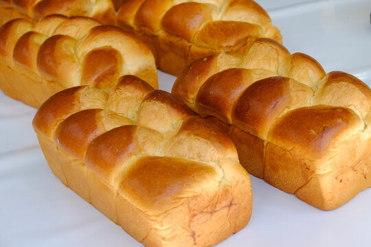 Golden brioche loaves in French bakery display