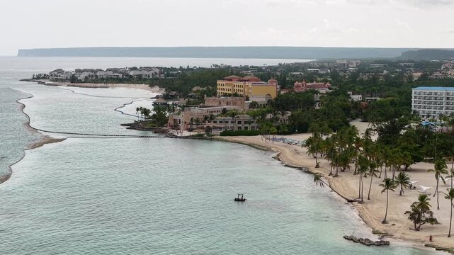 Cinematic aerial drone footage of Punta Cana, Dominican Republic featuring turquoise Caribbean waters, white sand tropical beaches, luxury resorts, palm trees, and stunning coastline views at sunrise