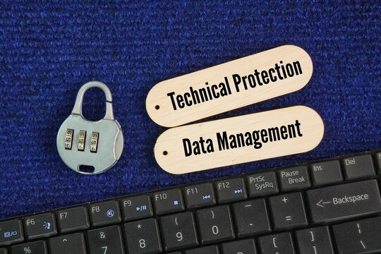 Laptop keyboard, keys and sticks with the words Securing personal privacy involves a two-part approach focusing on both technical protection -security and data management -privacy.