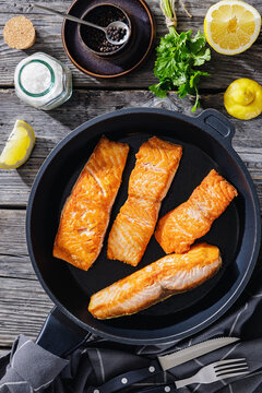 Pan-seared salmon fillets on a skillet, close-up