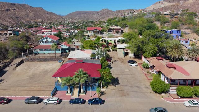 Watch aerial views of Santa Rosalia in Baja California Sur showcasing the town layout, church, and surrounding landscape.