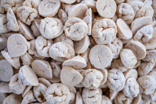 Sun-dried black gram dumplings, known as daler bori, displayed at a rural Bangladeshi village market. A traditional homemade ingredient used in everyday Bengali cooking