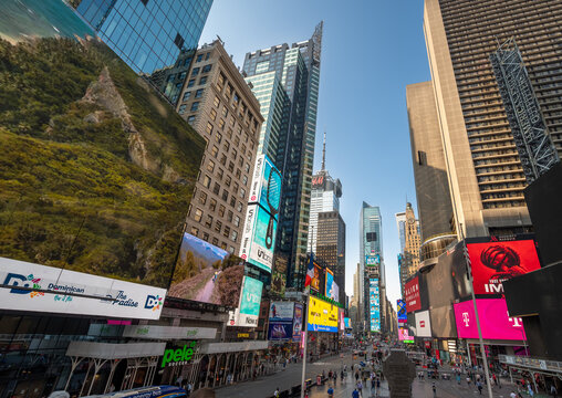 New york, usa august 14,2024. Times square showing famous skyscrapers, vibrant digital billboards, and bustling street level activity under a clear sky