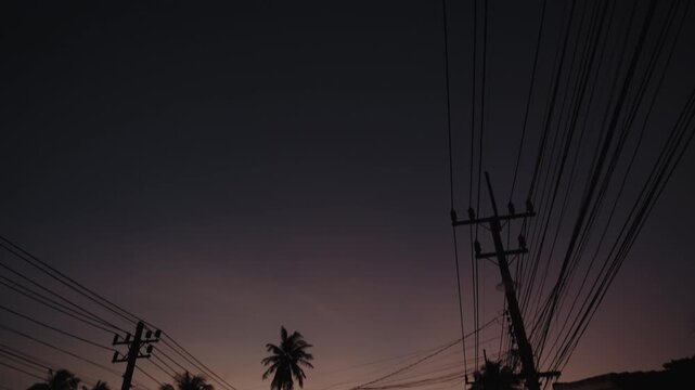 Cinematic Vertical Tilt-Down from Crescent Moon in Deep Purple Twilight Sky to Silhouetted Tropical Street and Palm Trees, Koh Samui, 4k Slow Motion Video