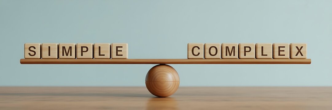 A wooden balance scale with blocks spelling simple and complex on either side